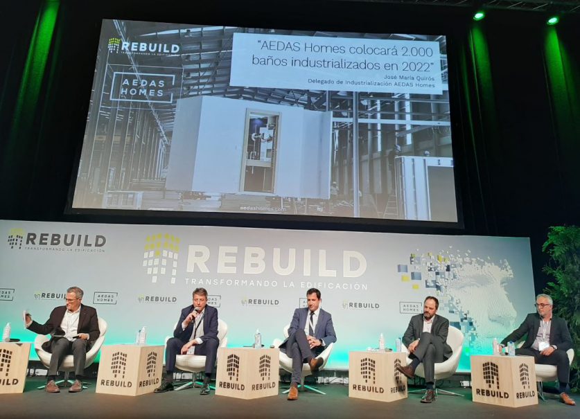 José María Quirós (segundo por la izquierda), Delegado de Industrialización de AEDAS Homes, en la mesa de baños industrializados en REBUILD 2022.